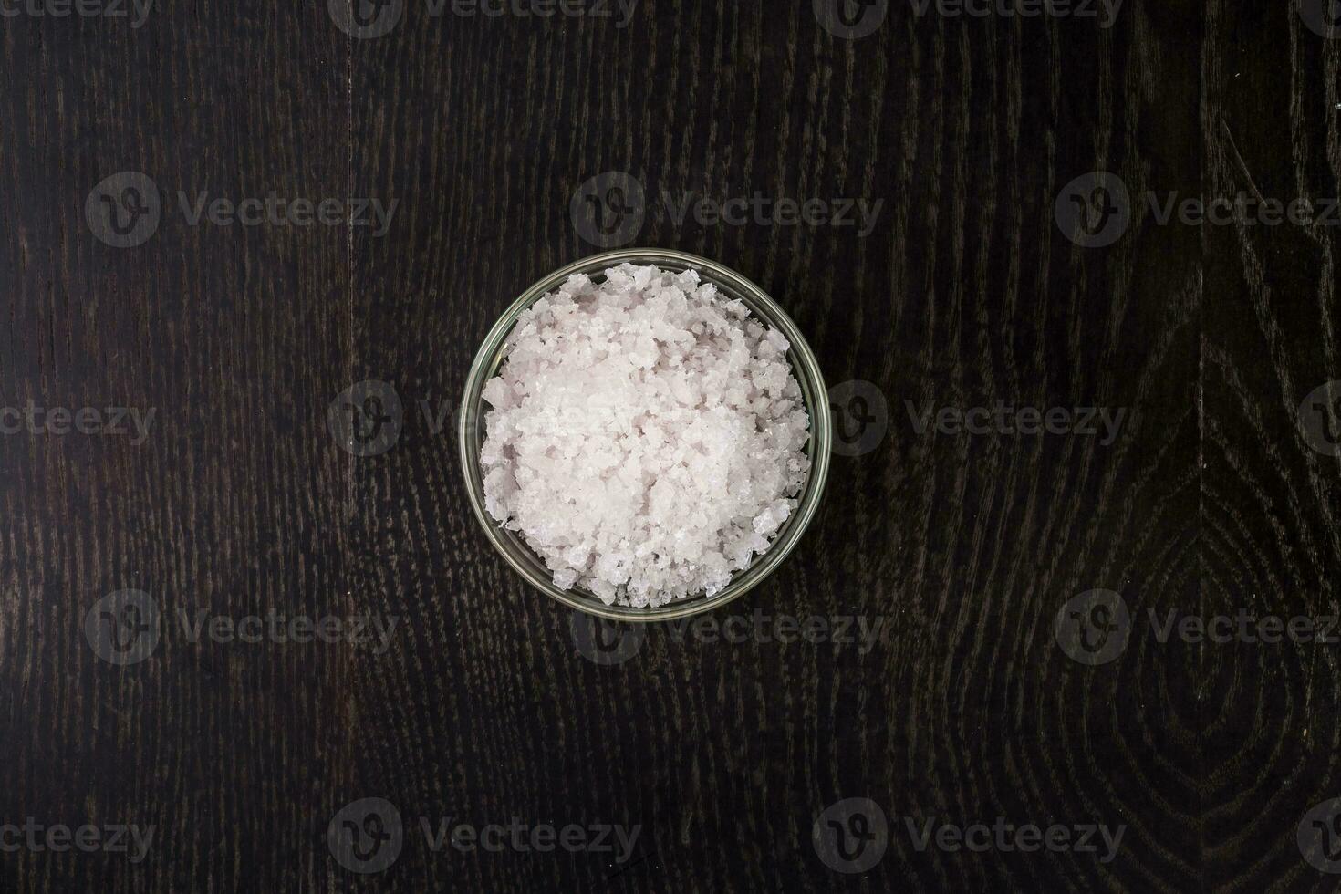 sel dans une verre bol - Haut voir. sur noir Contexte. photo