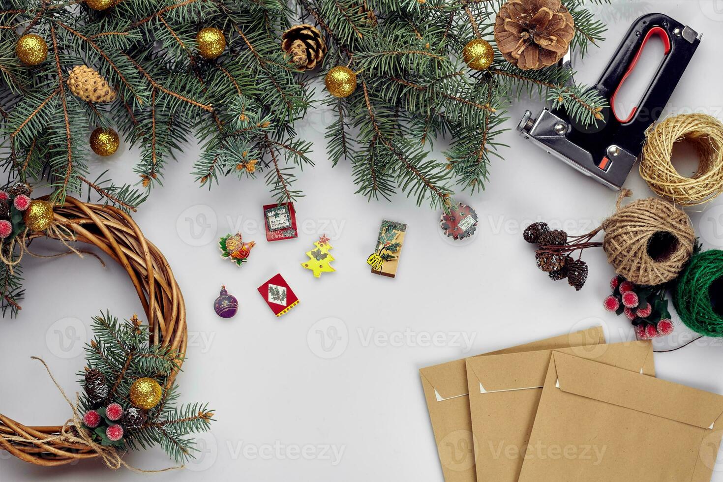 Créatif Noël DIY. femme fabrication Fait main Noël couronne. Accueil loisirs, outils, babioles et détails pour vacances décorations sur blanc table Contexte. Haut vue photo