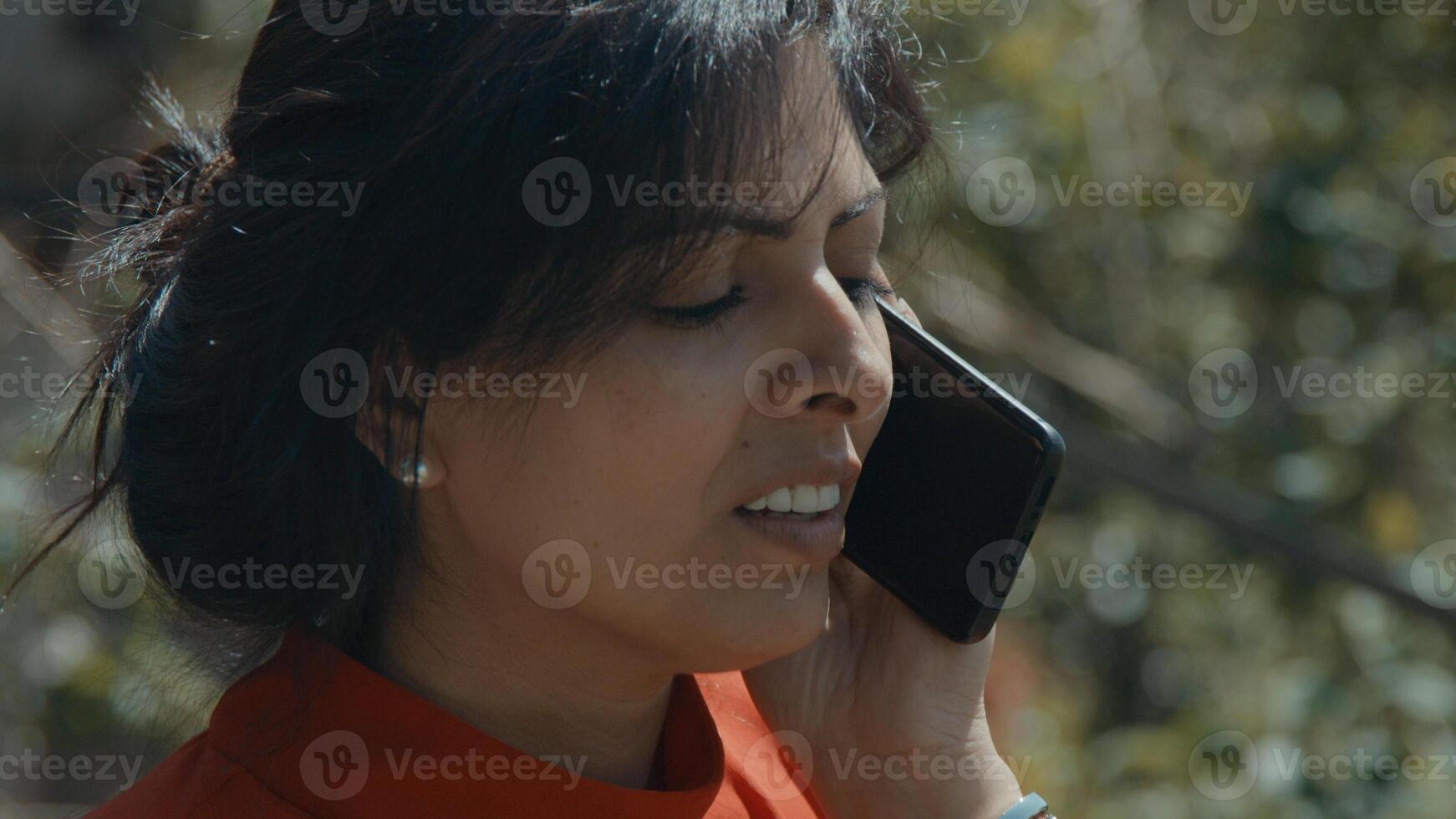 femme debout devant un arbre appelant avec un smartphone photo