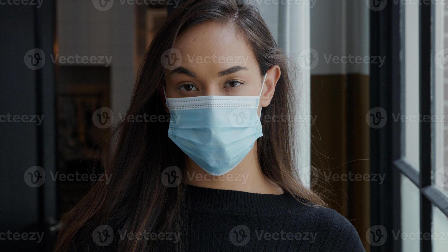 head shot of young mixed race woman in face mask photo