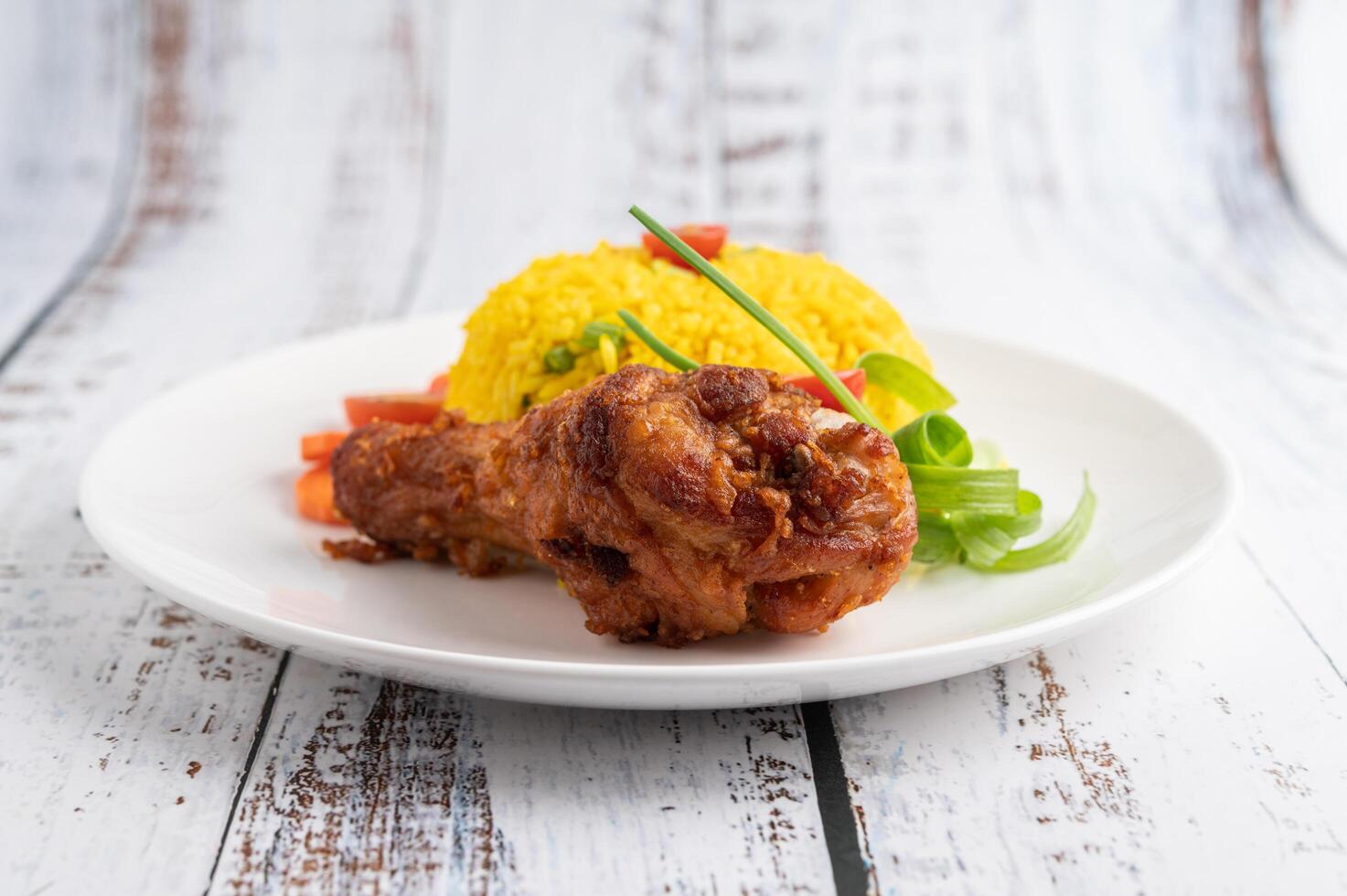 poulet biryani dans une assiette sur un plancher en bois blanc photo