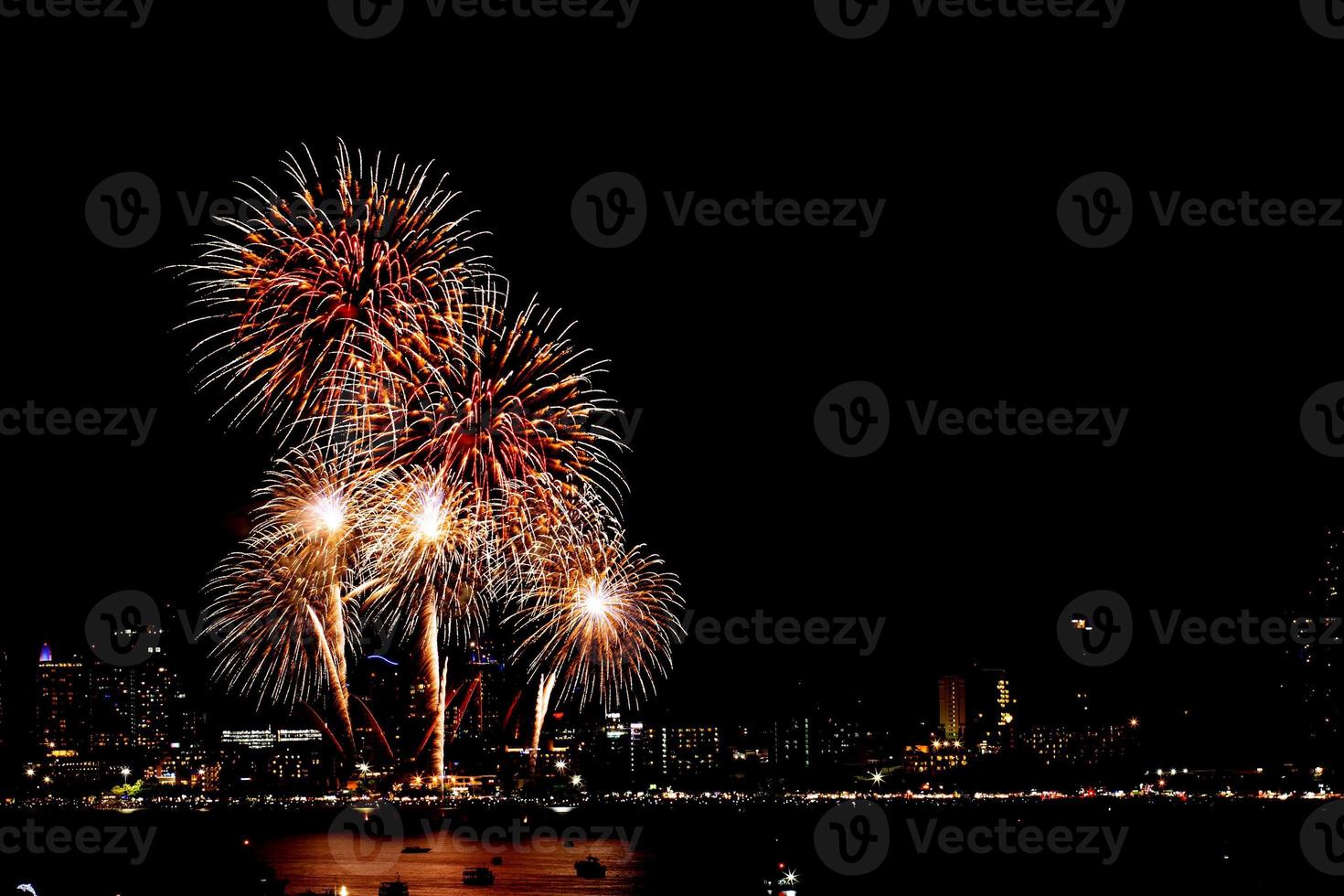 de nombreux feux d'artifice clignotants avec fond de paysage urbain de nuit nouvel an. photo