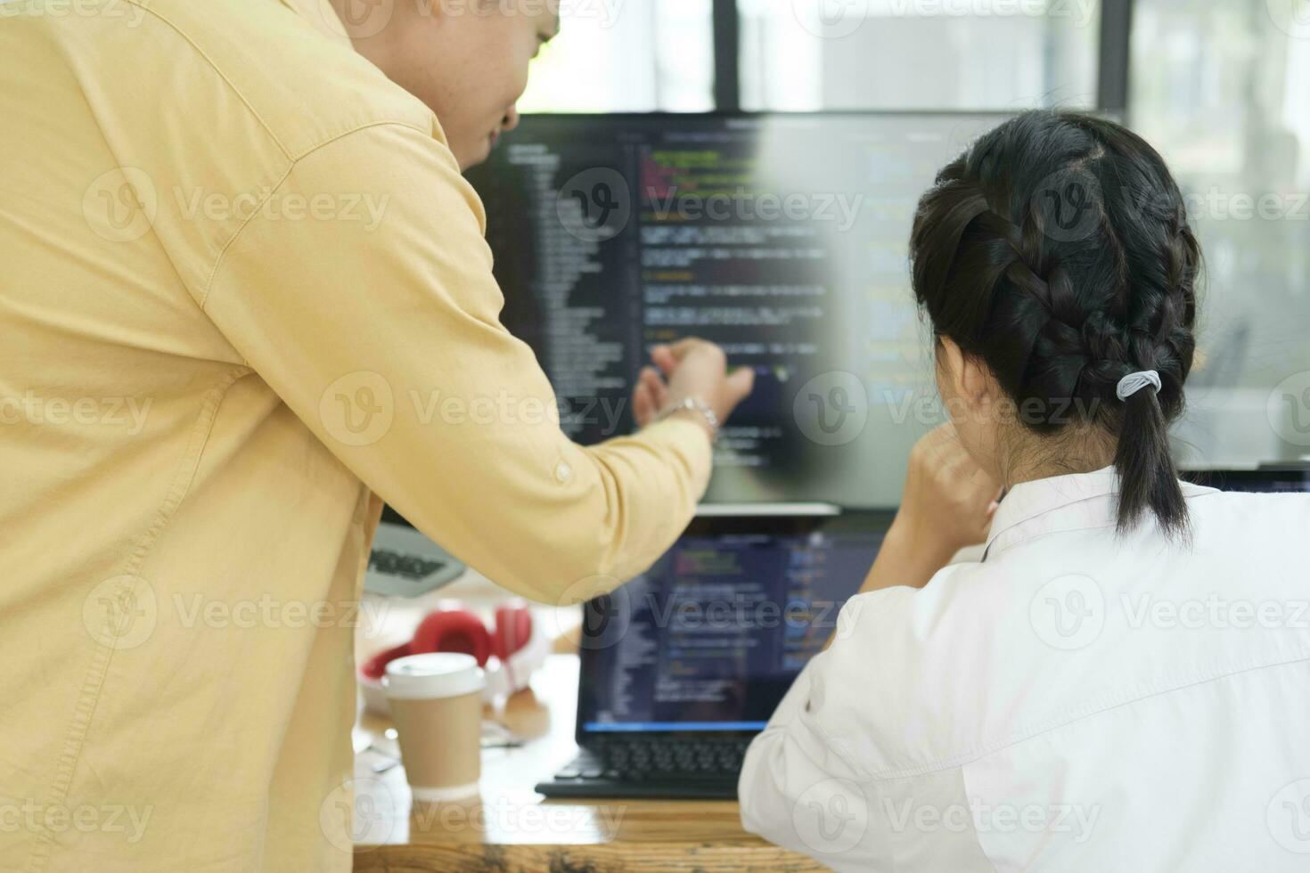 équipe de Jeune ordinateur programmeurs coopérer tandis que travail sur bureau PC dans le bureau. photo