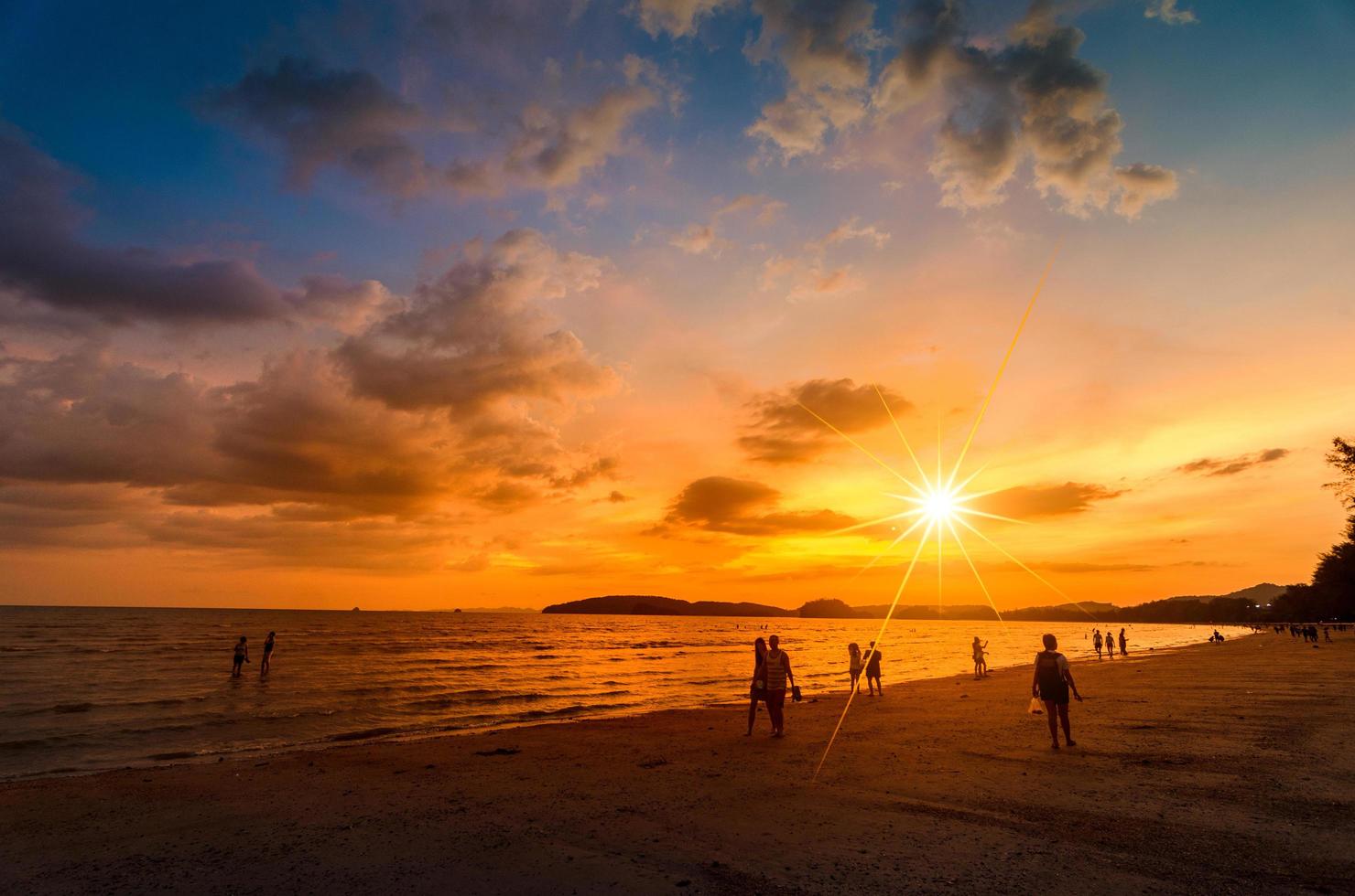 ao nang krabi, thaïlande, 2020 - personnes sur la plage au coucher du soleil photo