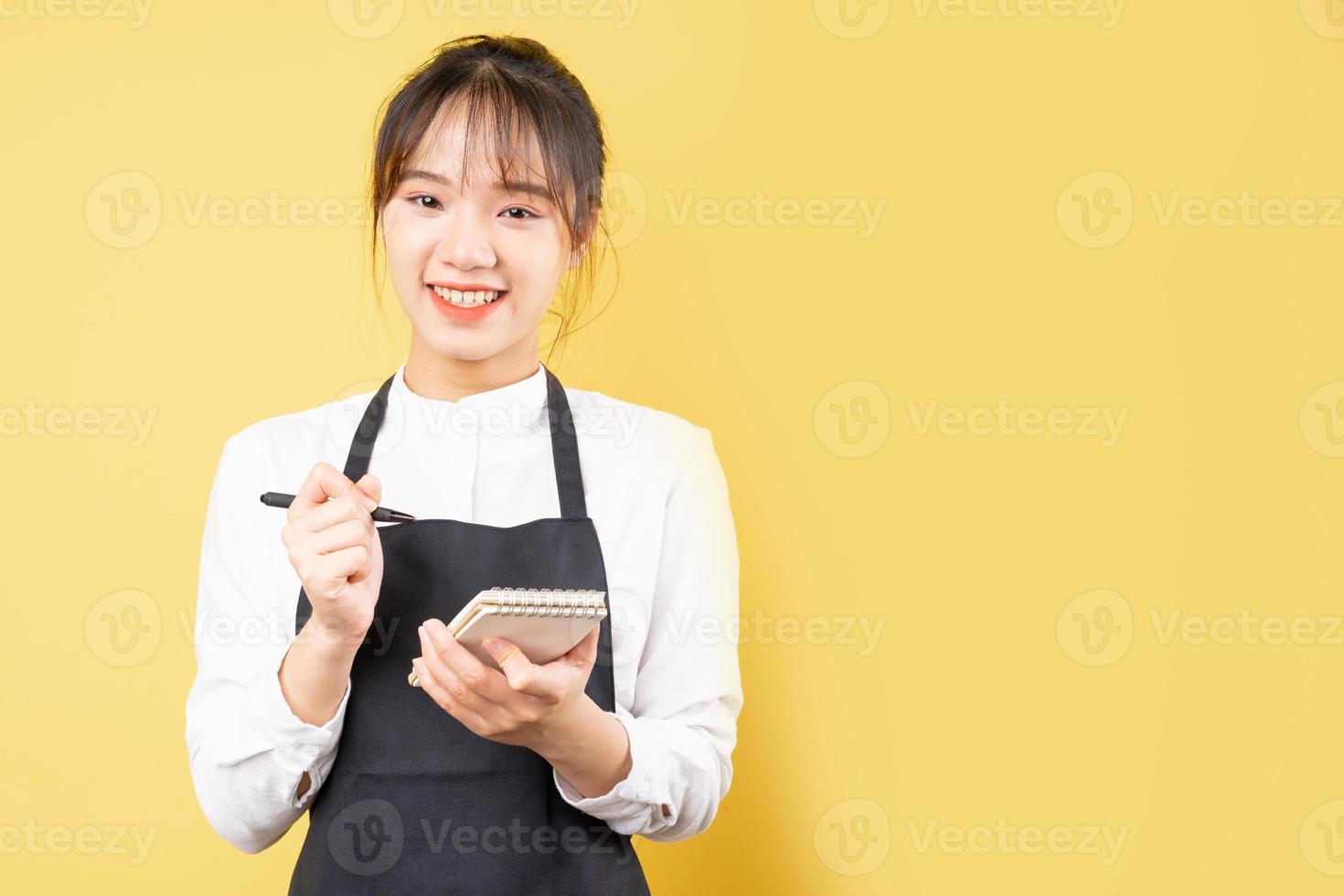 Portrait de serveuse joyeuse sur fond jaune photo