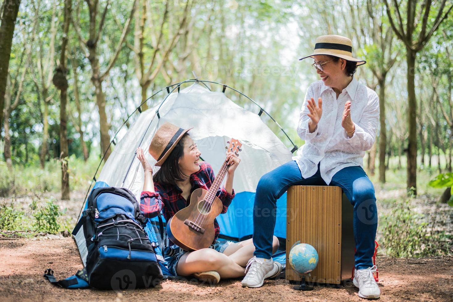 fille asiatique et mère jouant de la musique dans la forêt en plein air. concept de personnes et de modes de vie. thème nature et voyage photo