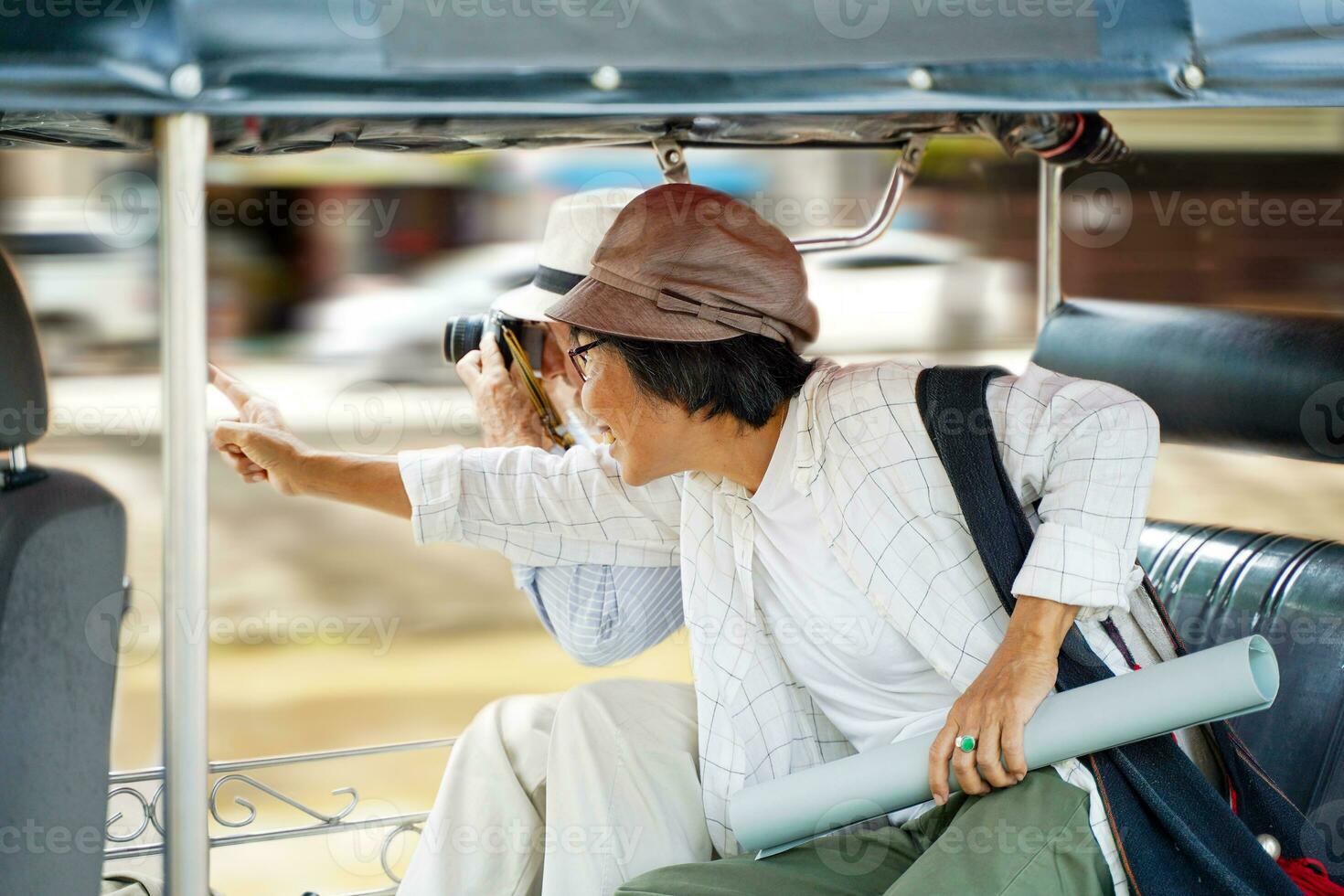 fermer américain Sénior touristique homme prendre une ville tour tuktuk Thaïlande Taxi et prendre une photo avec le sien tour guider montrer du doigt en dehors le intéressant des endroits dans le ville. Sénior touristique concept