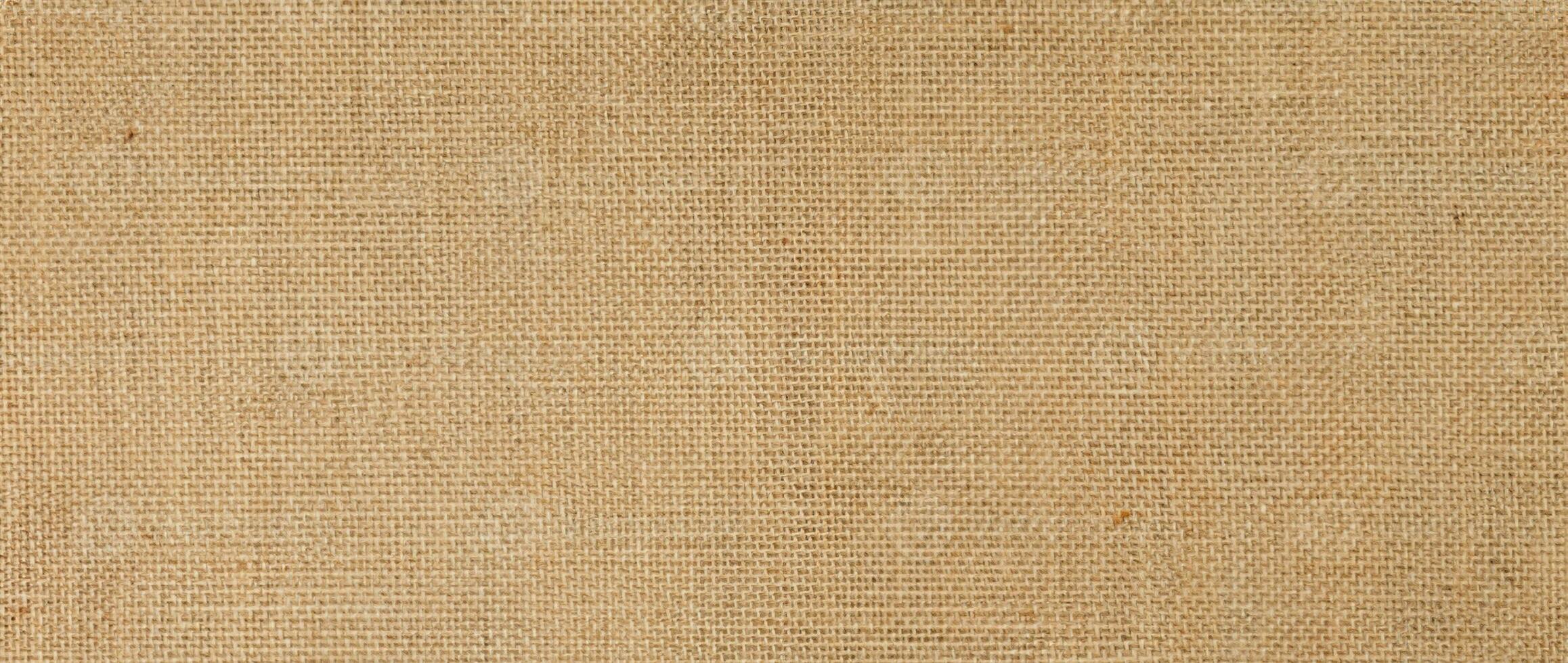 toile de jute toile à sac toile de jute tissé texture arrière-plan, coton tissé en tissu Contexte avec taches de variant couleurs de beige et marron. avec copie espace. Bureau bureau concept. photo