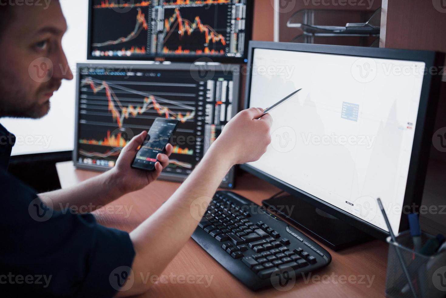 agent de change en chemise travaille dans une salle de surveillance avec écrans d'affichage. concept graphique de finance forex trading bourse. hommes d'affaires négociant des actions en ligne photo