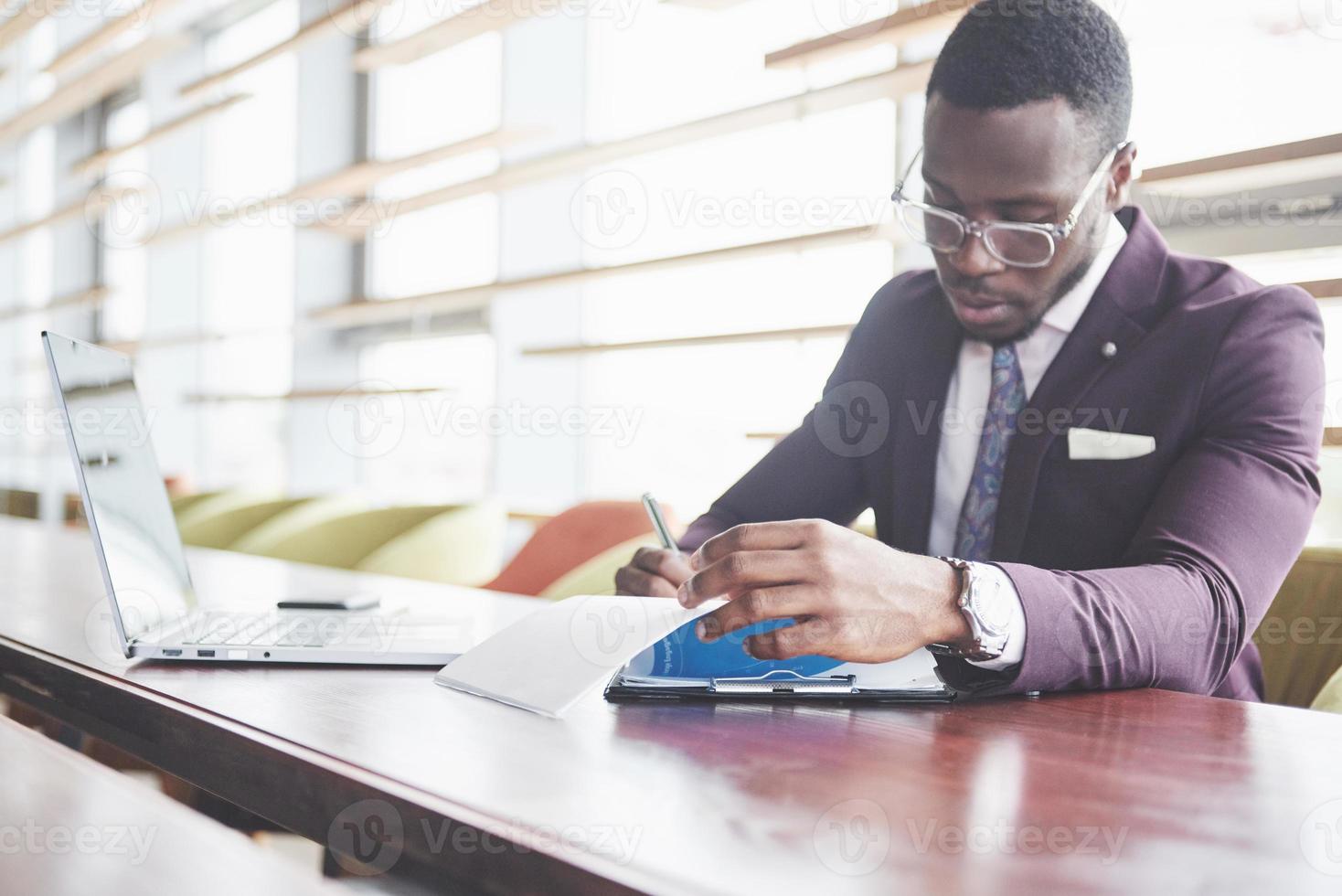 un jeune homme d'affaires signe un contrat dans une salle de conférence photo