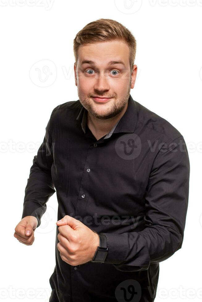 Beau homme dans une noir chemise, isolé sur une blanc arrière-plan, sentiment génial et confortable. photo