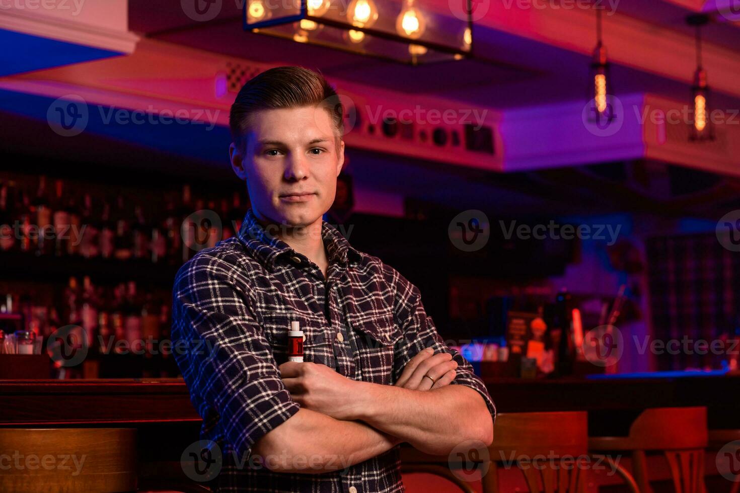 le homme fumée un électronique cigarette à le vape magasin. photo