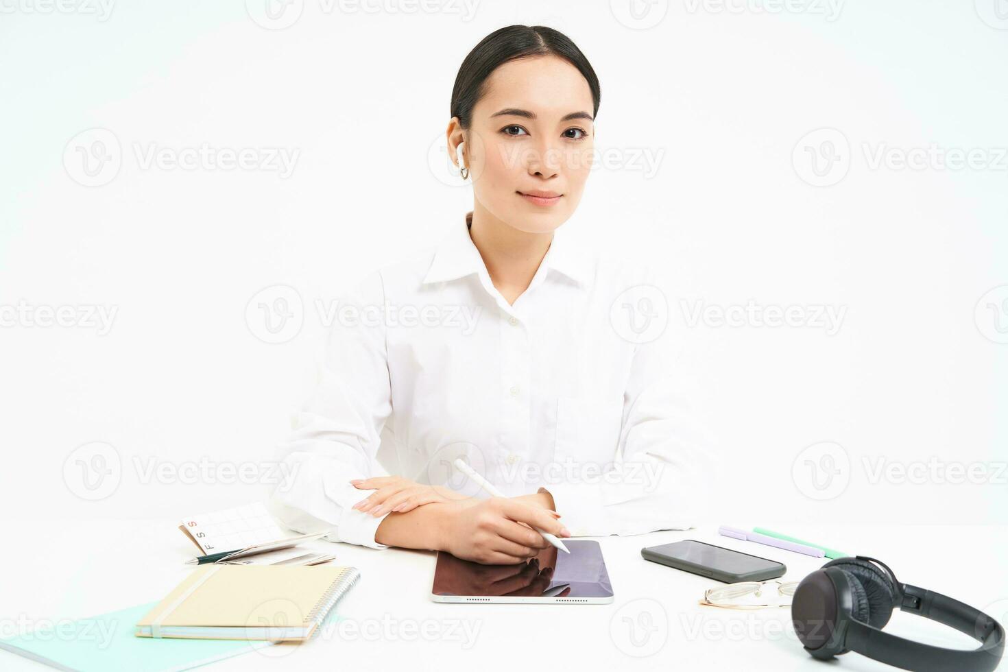 Jeune femme d'affaires est assis dans sa Bureau et écrit sur numérique tablette, travail dans sa entreprise, isolé sur blanc Contexte photo