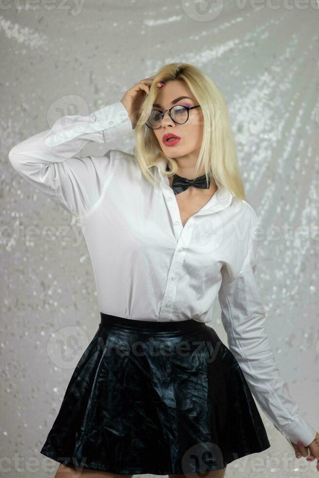blond femme portant des lunettes et un noir cuir jupe photo