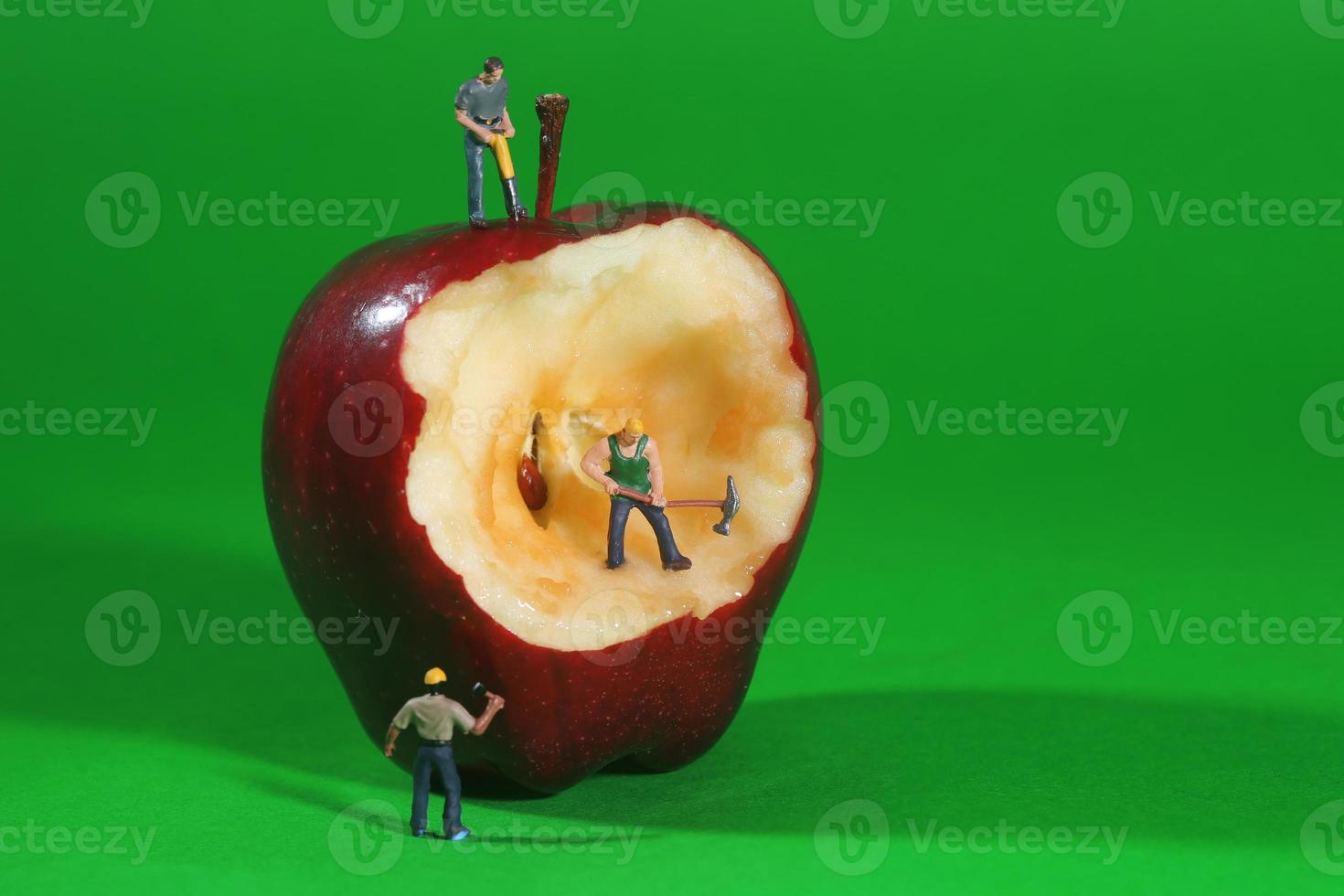 travailleurs de la construction dans l'imagerie conceptuelle avec une pomme photo