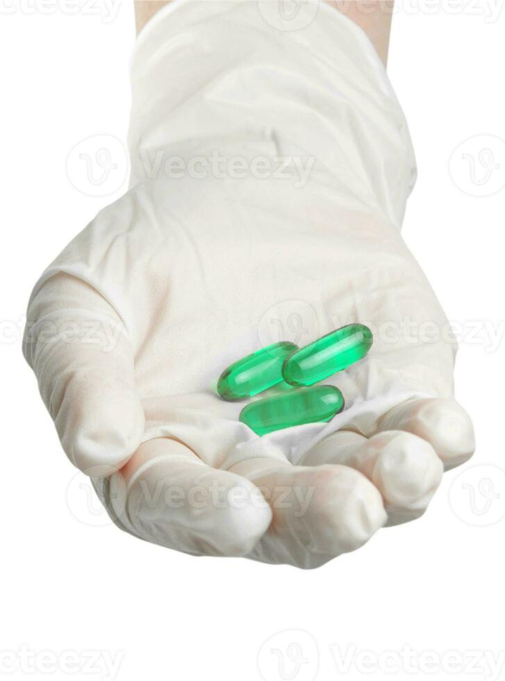 main avec gants et pilules photo