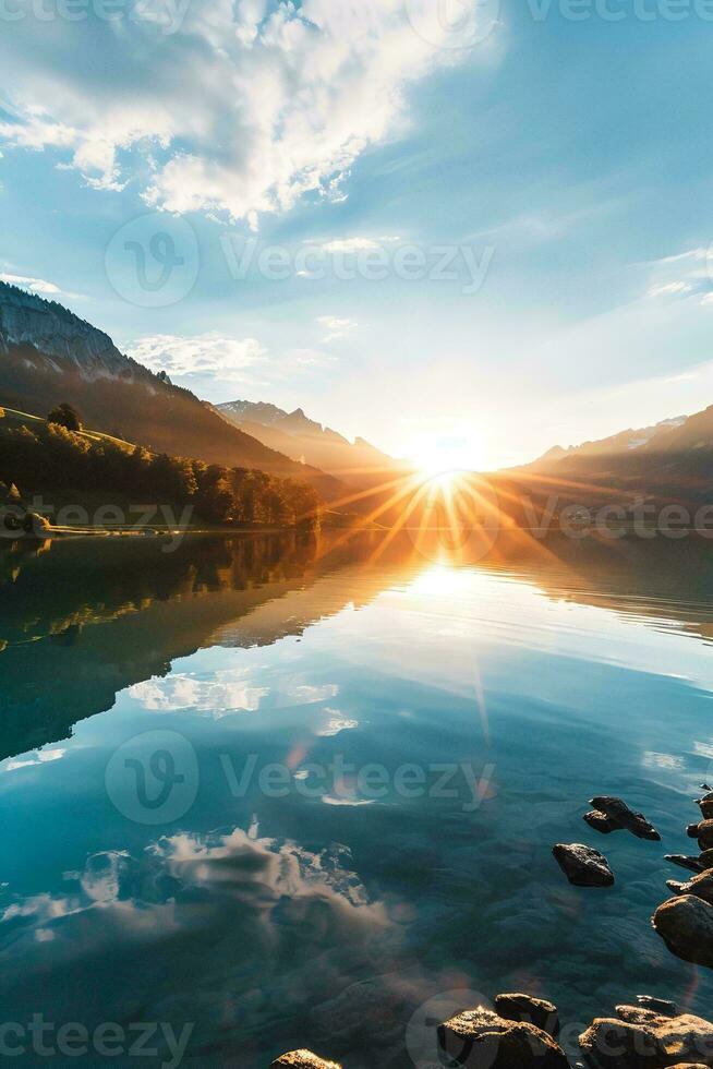 ai généré une étourdissant lever du soleil scène. Soleil des rayons transpercer par le horizon moulage une d'or teinte. le Soleil est réfléchi dans une calme et clair lac. rochers sont visible à le bord de le l'eau photo