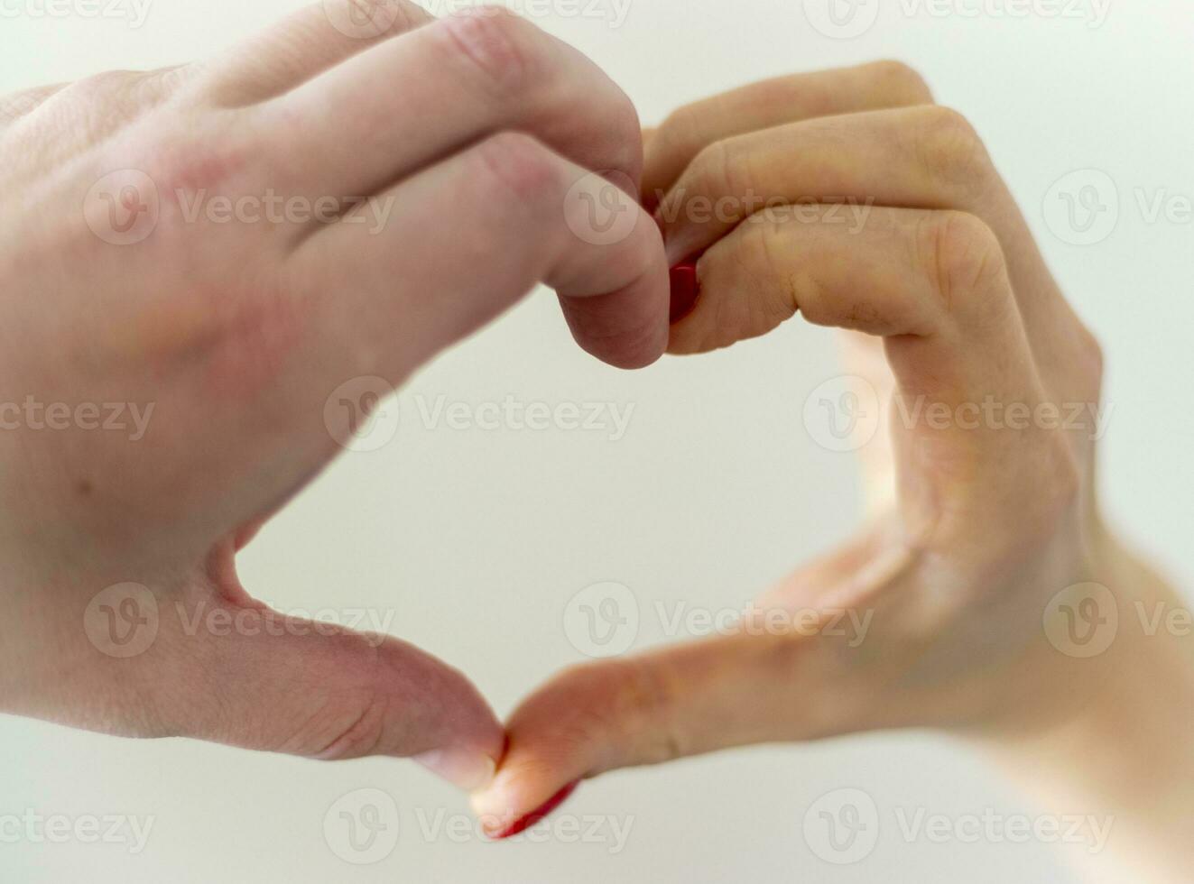 homme et femme en portant leur mains dans le forme de le cœur comme une symbole de l'amour. valentines journée photo