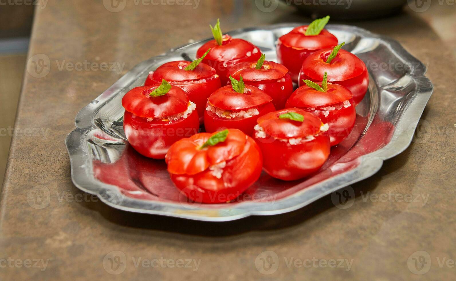 arrangement de farci tomates avec Frais menthe feuilles sur métal plateau dans cuisine photo