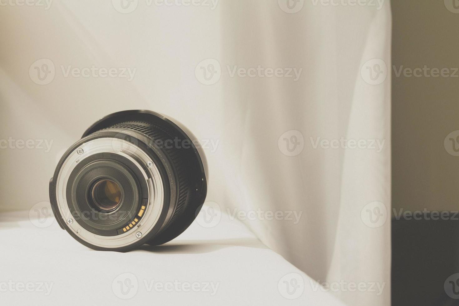 Objectif zoom de caméra noir sur tissu blanc photo