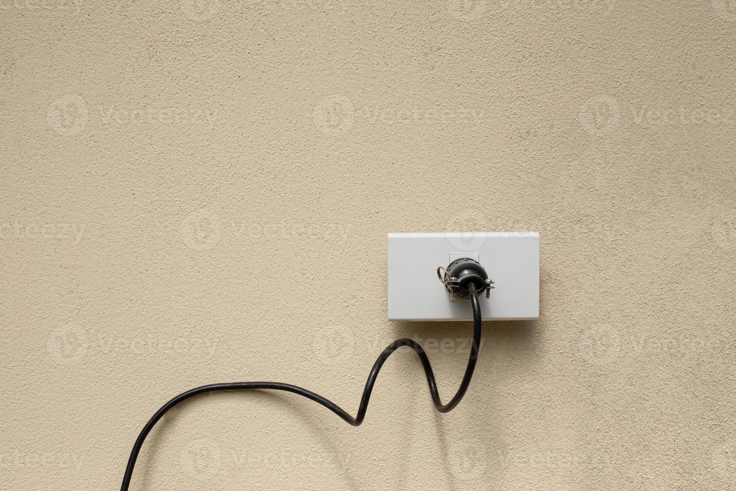 prise de courant de fil électrique sur le fond de mur en béton photo