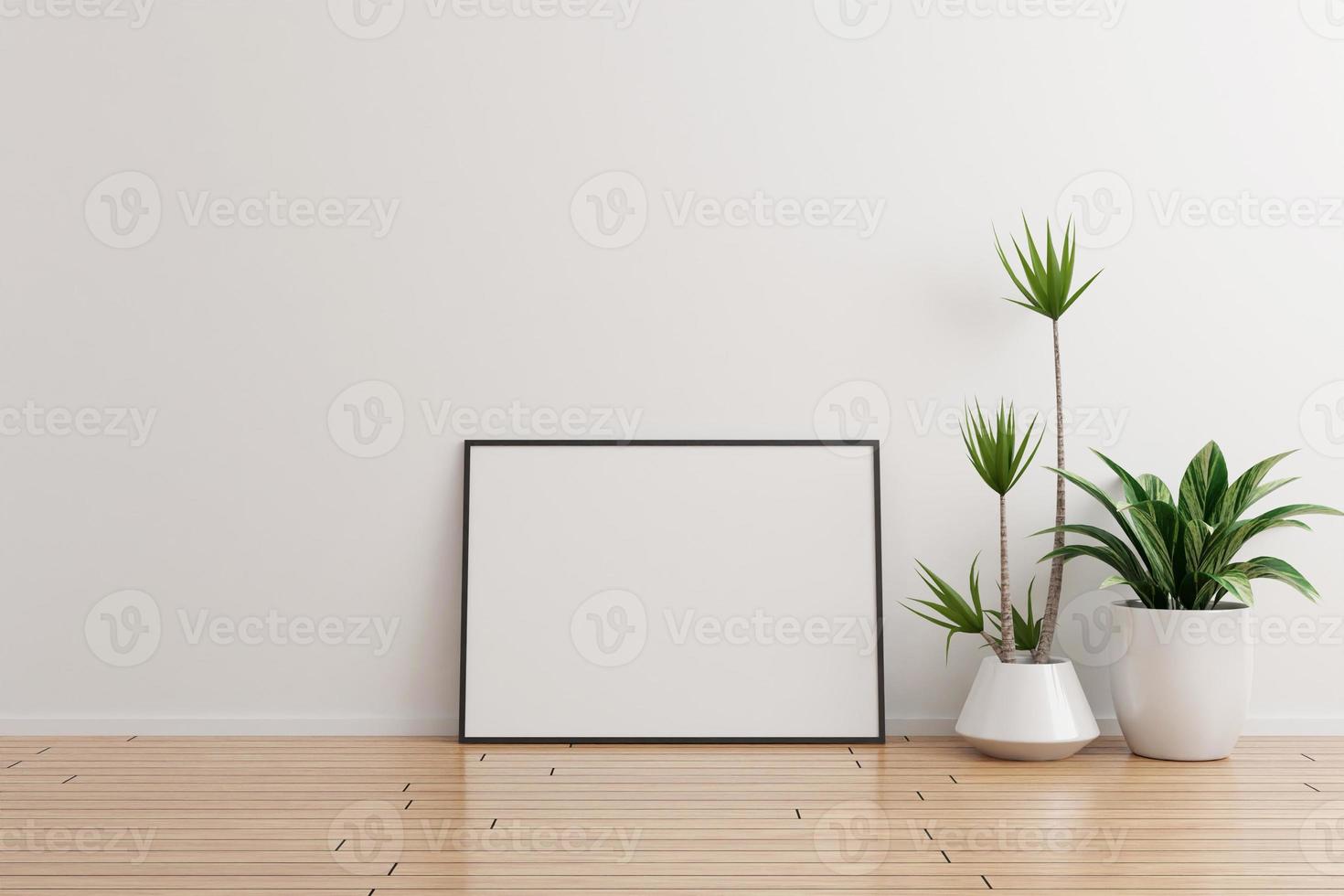 maquette de cadre photo horizontal noir sur un mur blanc pièce vide avec des plantes sur un plancher en bois