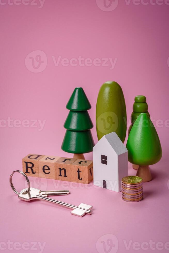 petit en bois maison et le une inscription pour louer. concept pour vente, de location de réel biens pour une famille photo