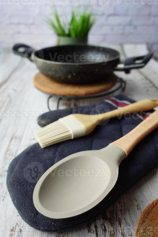 en bois coutellerie fourchette et cuillère et cuisine la poêle sur table photo