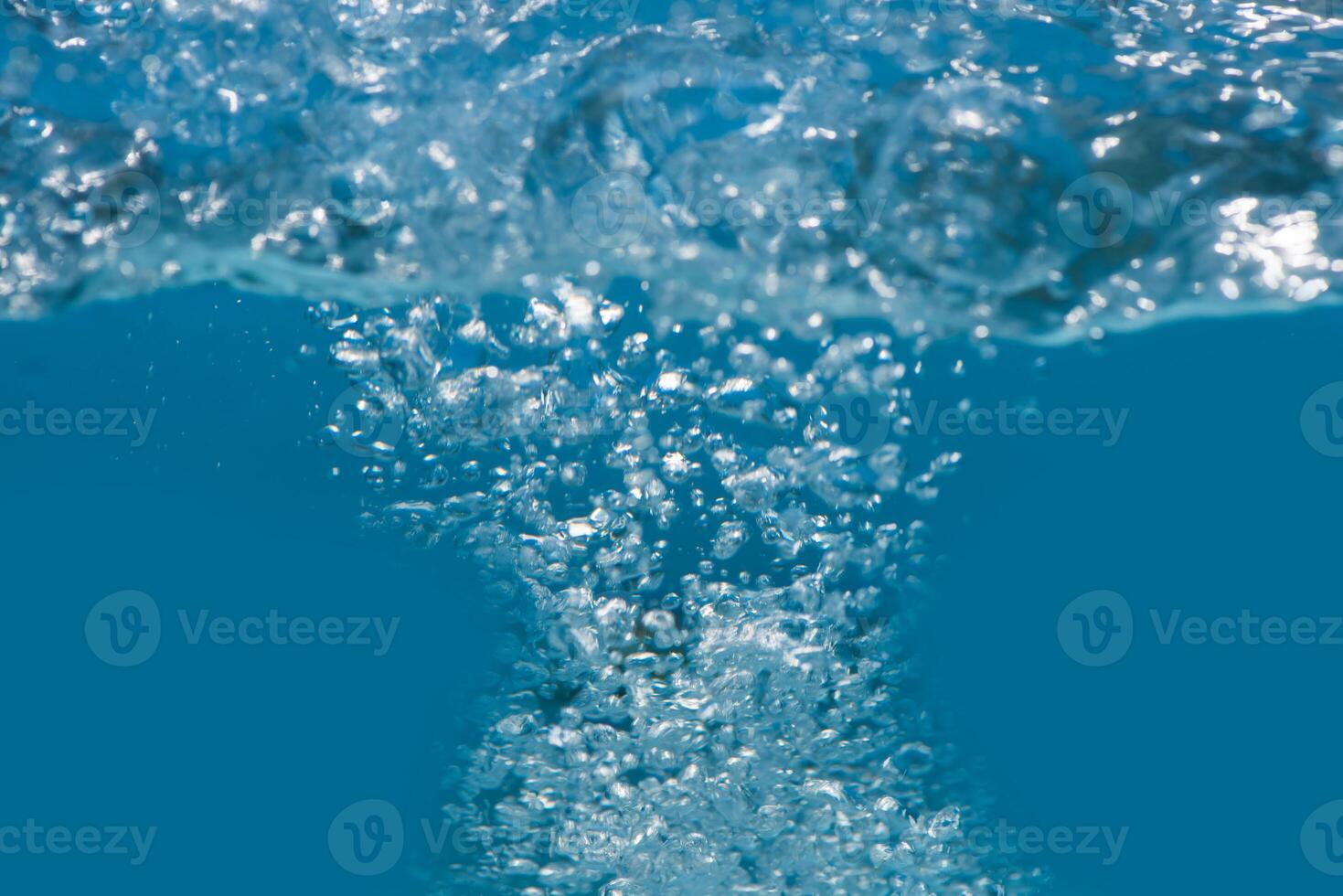 l'eau bleue vagues sur le surface ondulations flou. défocalisation flou transparent bleu coloré clair calme l'eau surface texture avec éclaboussure et bulles. l'eau vagues avec brillant modèle texture Contexte. photo