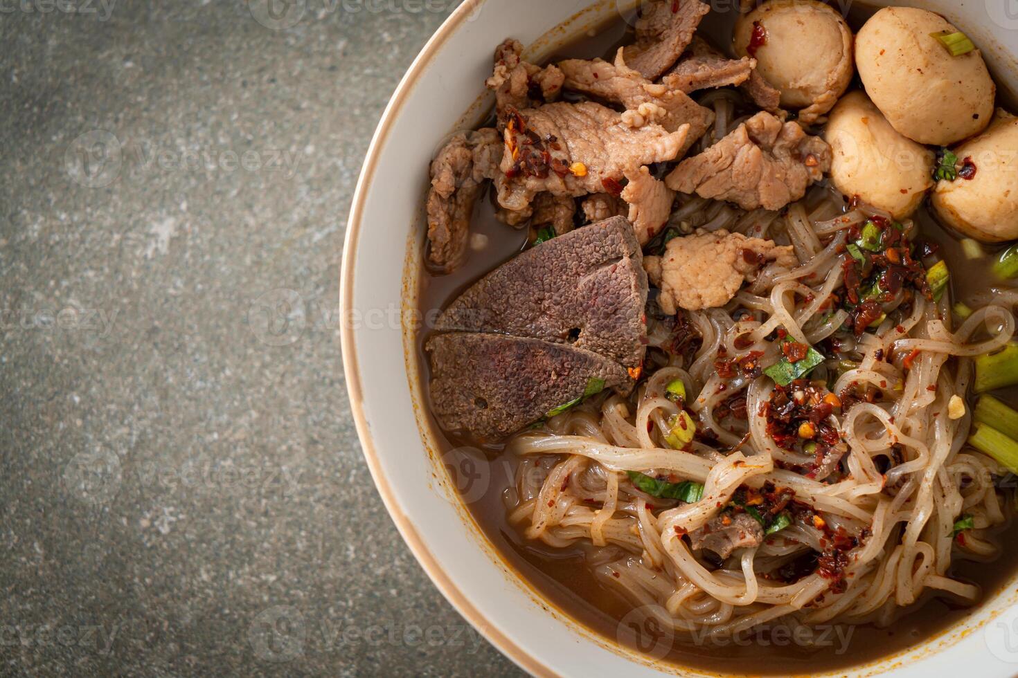 nouilles thaï au porc, ragoût de porc, boulette de viande et foie de porc dans une soupe de sang photo