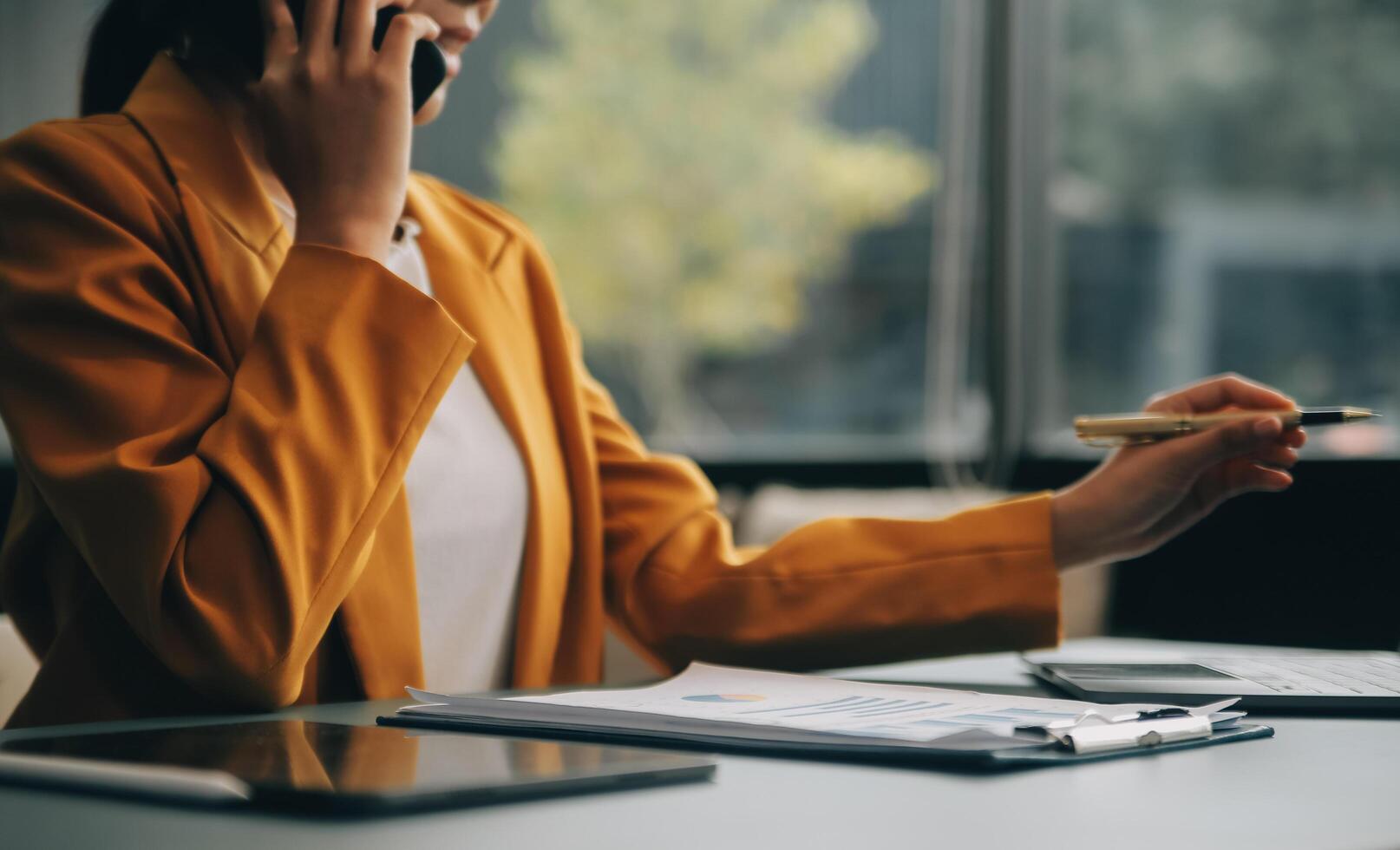 femme d'affaires asiatique en costume formel au bureau heureuse et joyeuse lors de l'utilisation d'un smartphone et du travail photo