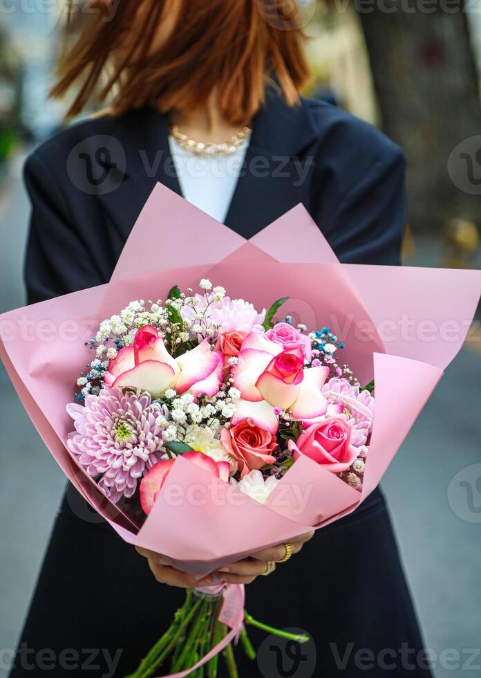 femme tenant un bouquet de fleurs photo