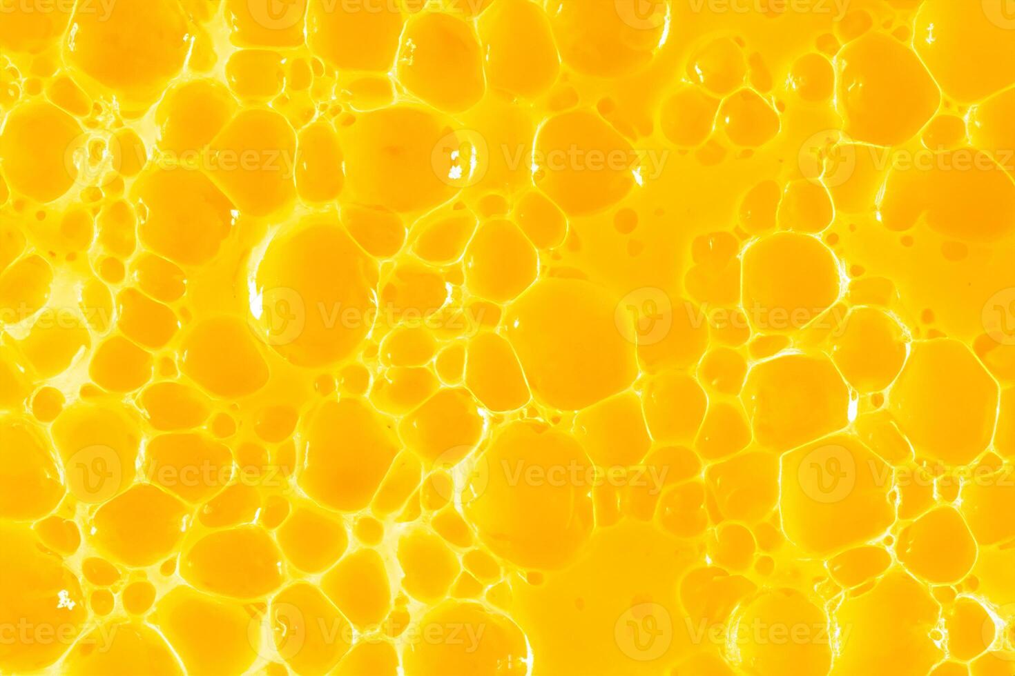 Orange jus. bulle Jaune texture Contexte. baie gel à purifier le peau de le visage et corps. spa traitements, peau se soucier. une baignoire mousse, détergent. or vase photo