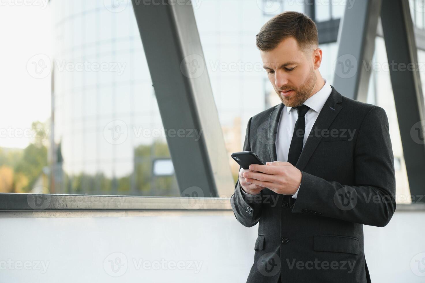 agent de change près le bureau. une réussi et Avancée Beau affaires homme dans une costume regards en haut dans de face de lui permanent sur le Contexte de béton pas. photo