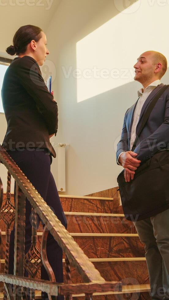 femme d'affaires réunion homme collègue dans entreprise Bureau salutation avec poignée de main accueillant et parlant sur escaliers. équipe de professionnel hommes d'affaires travail dans moderne financier bâtiment salutation. photo