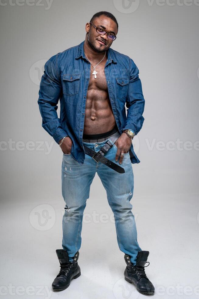 sexy Beau afro homme posant à studio. musclé homme à la recherche à caméra. plein longueur photo de musclé Masculin.