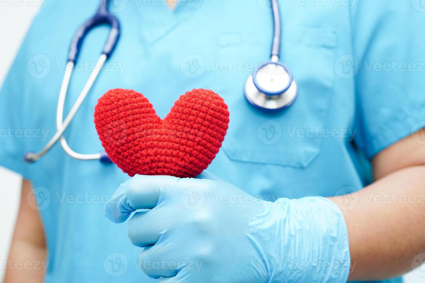 femme médecin asiatique tenant un coeur rouge pour la santé à l'hôpital. photo