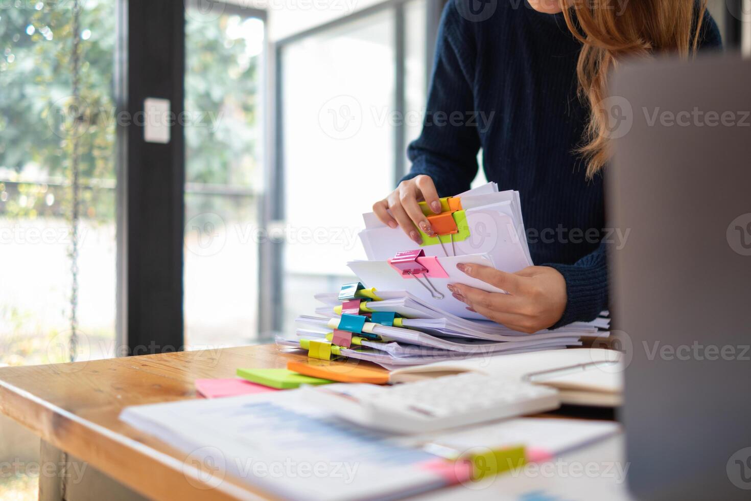 secrétaire est recherche par pile de important les documents sur Bureau table livrer leur à directeur pour présentation dans temps à réunion. concept de difficulté découverte information de piles de document photo