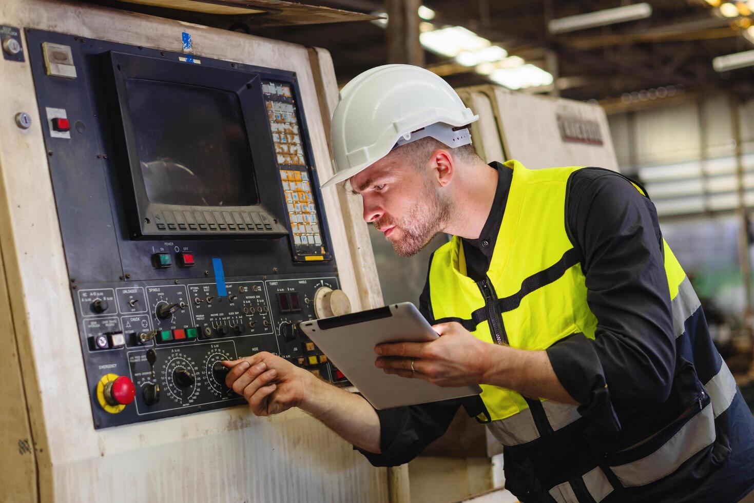 ingénieur Regardez projets et Planification avec tablette mobile dans usine photo