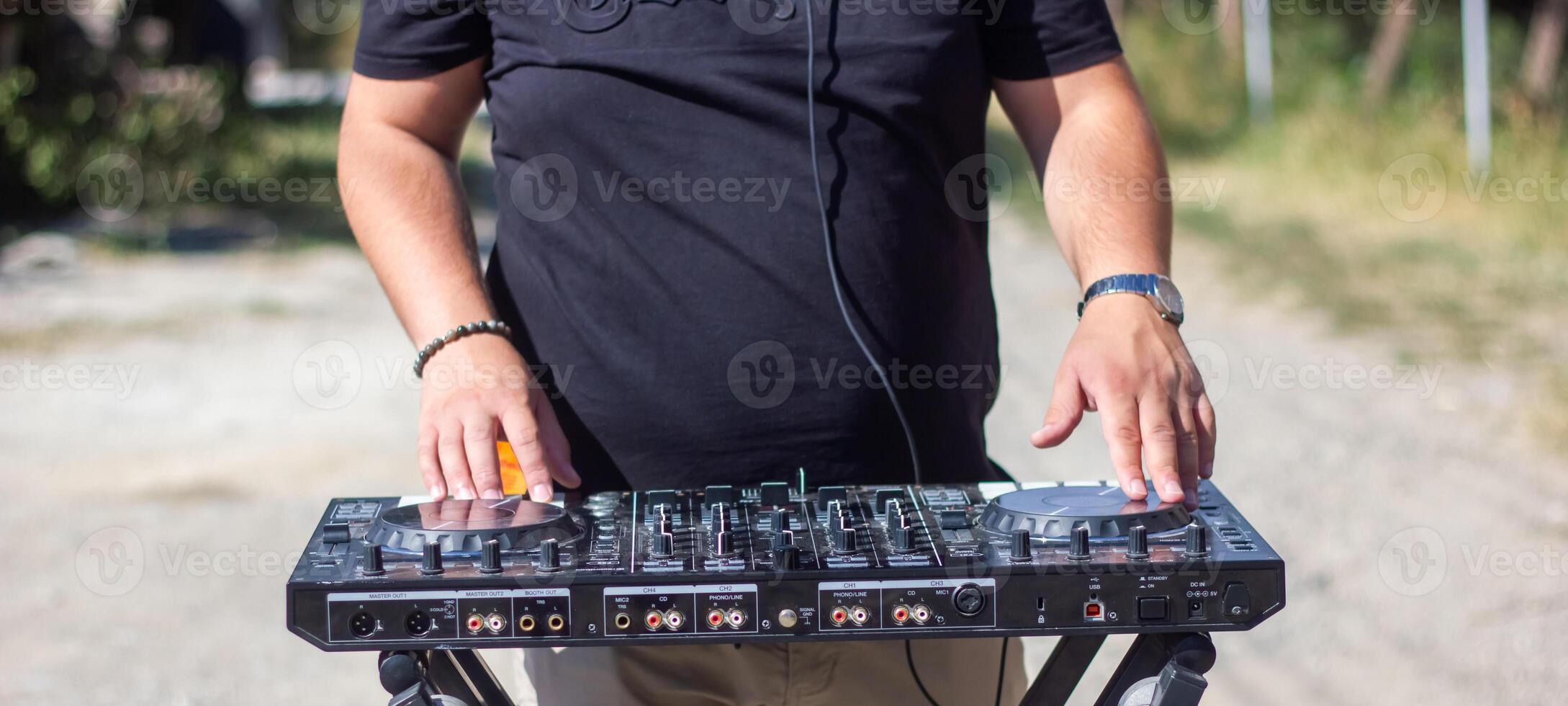 dj avec écouteurs et mixer dans le parc, le dj à travail photo