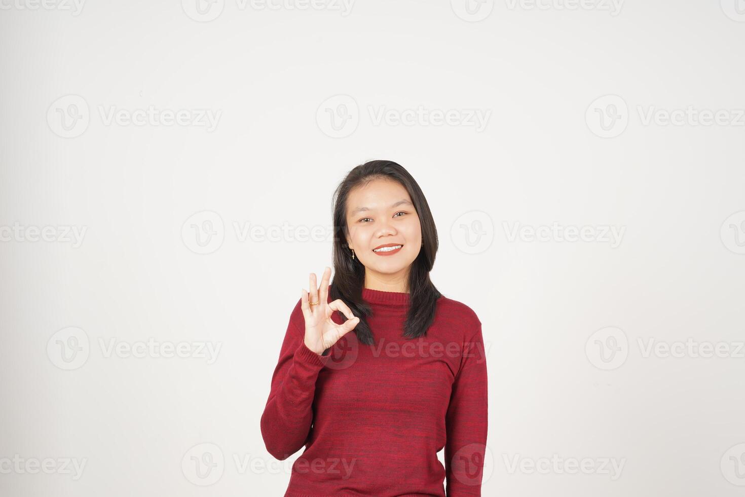 Jeune asiatique femme dans rouge T-shirt souriant et montrant d'accord signe isolé sur blanc Contexte photo