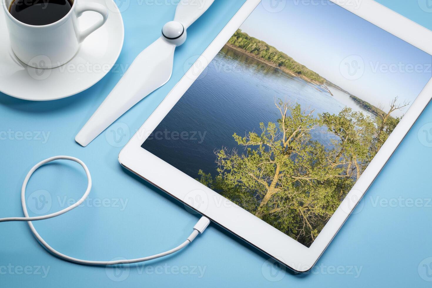 printemps lever du soleil plus de le Missouri rivière à Dalton bas - aérien image affiché sur une numérique tablette avec une tasse de café photo