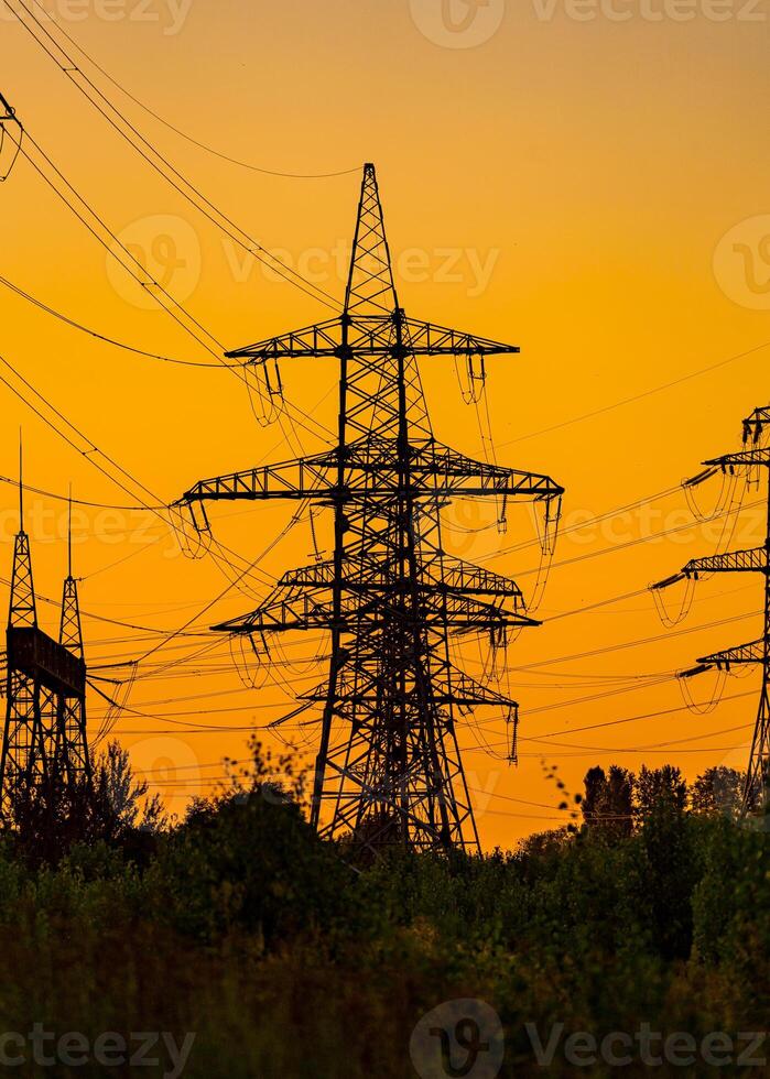 Puissance ligne dans le magnifique paysage de la nature. sélectif se concentrer. électricité pylônes palier le Puissance la fourniture à travers une rural paysage pendant le coucher du soleil. photo