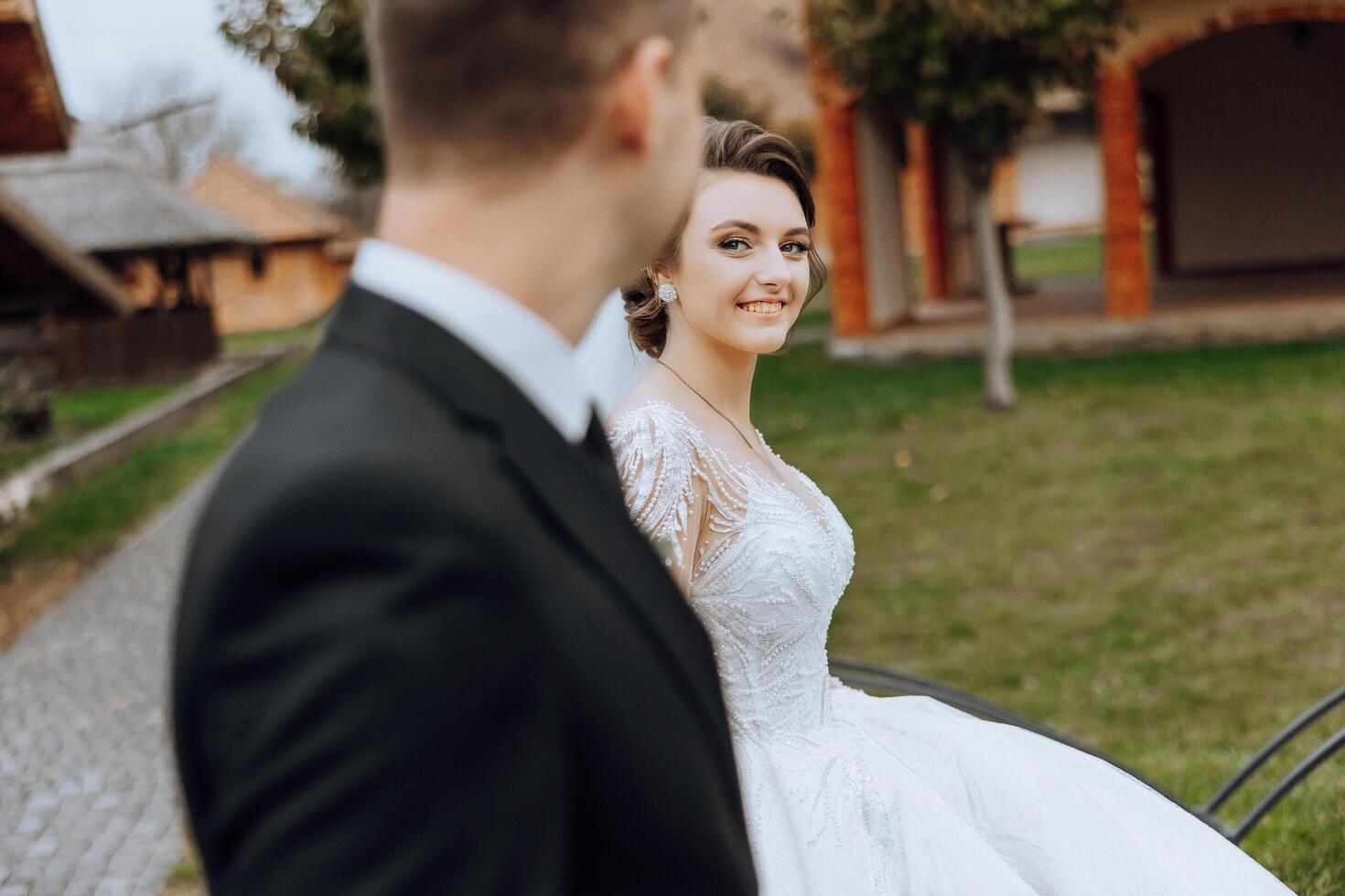 une mariage couple est en marchant dans la nature sur un l'automne journée. content Jeune la mariée et élégant jeune marié en portant mains. une élégant couple de jeunes mariés sur leur mariage journée. photo