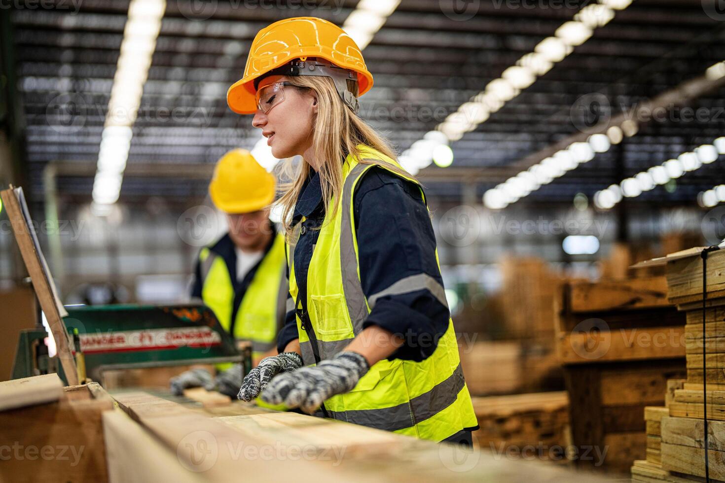 femme nettoyage Charpente bois dans foncé entrepôt industrie. équipe ouvrier Charpentier portant sécurité uniforme et difficile chapeau travail et vérification le qualité de en bois des produits à atelier fabrication. photo