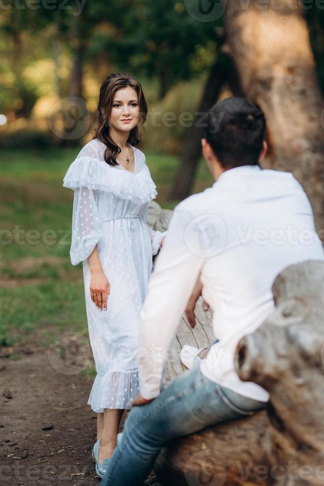 un gars et une fille marchent le long des sentiers d'un parc forestier photo