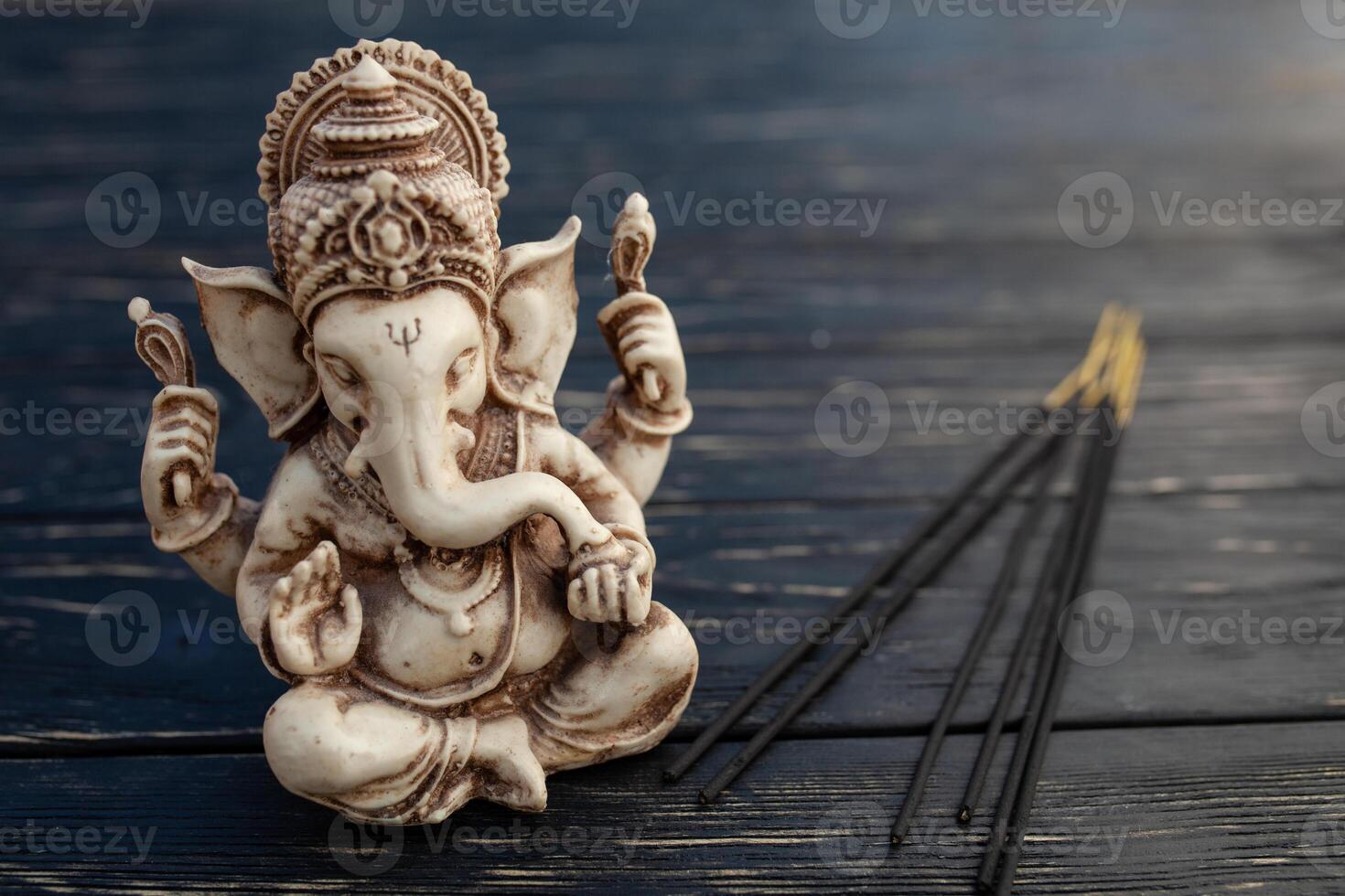 hindou Dieu ganesh sur noir Contexte. statue sur en bois table photo