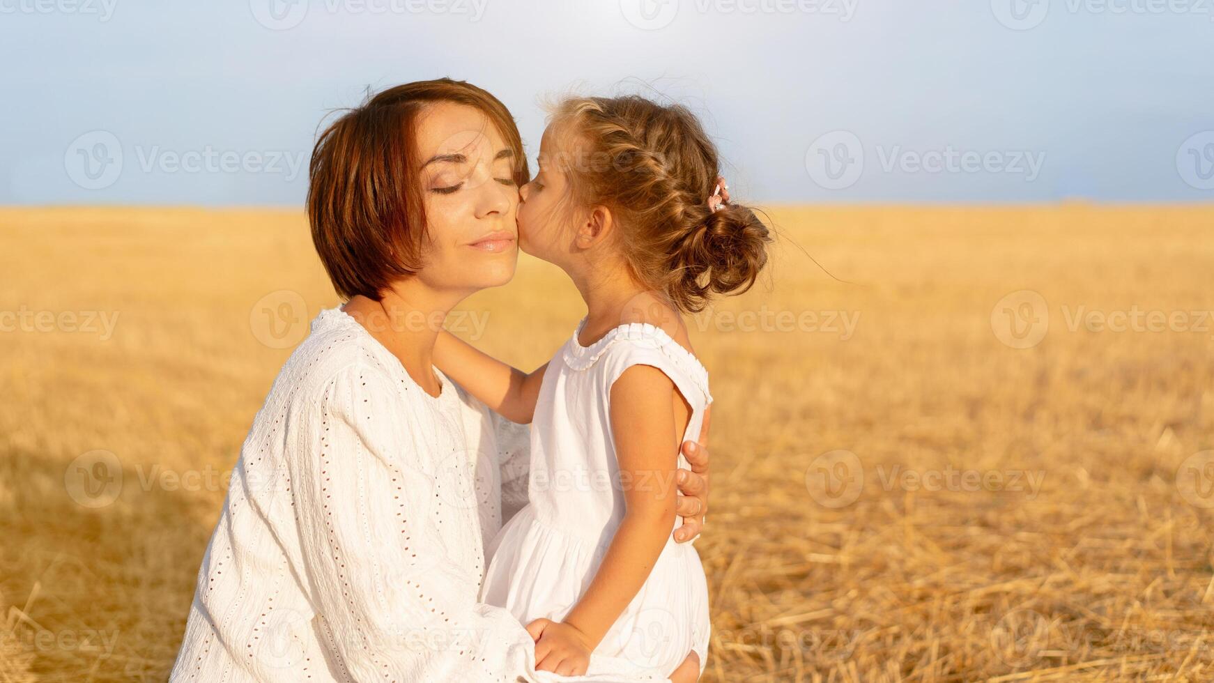 fille baisers sa maman joue permanent blé champ photo