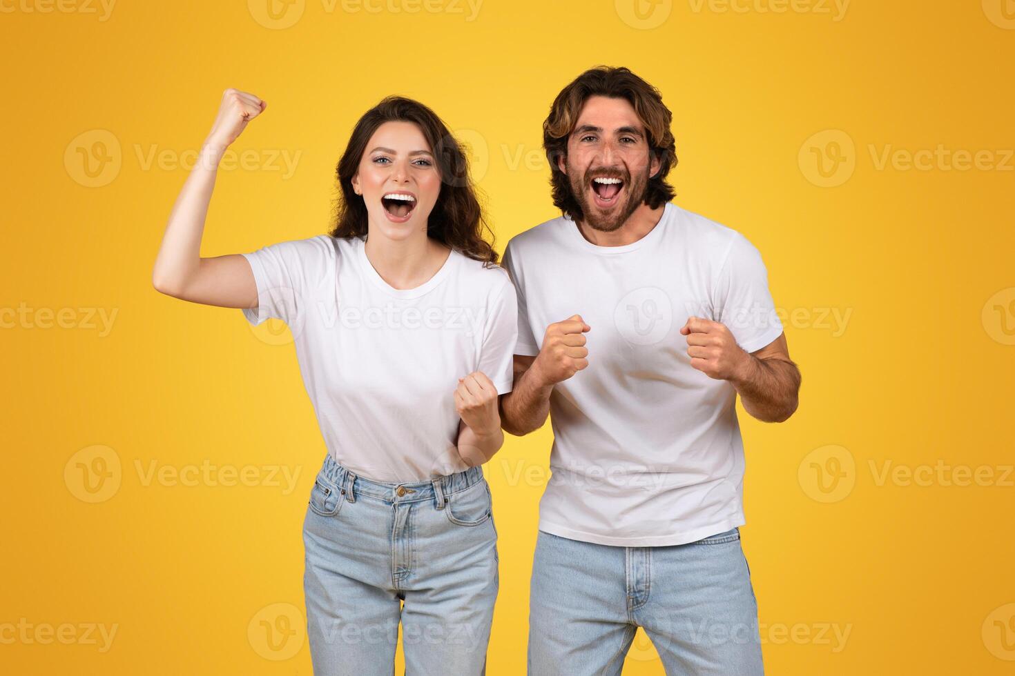 énergique Jeune couple avec élevé les poings célébrer une la victoire, exsudant joie et excitation photo