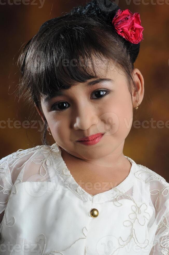 une Jeune asiatique fille portant Javanais traditionnel vêtements photo